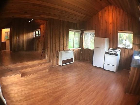 Large living room w/ an area to put your bed just off to the