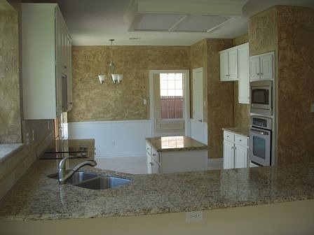 Kitchen w/ Granite Tops, S.S. Appliances and Custome Backsplash