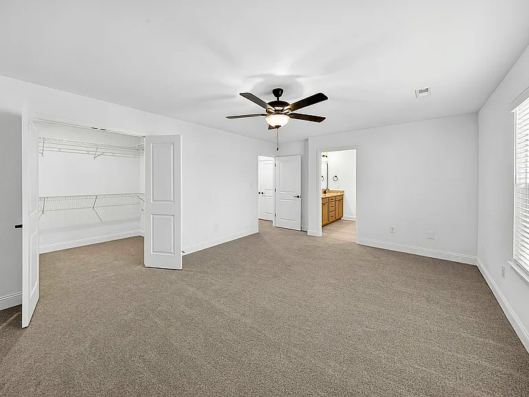 Primary bedroom showing flow to closet and bath