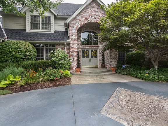 Double front doors leas to two-story entry