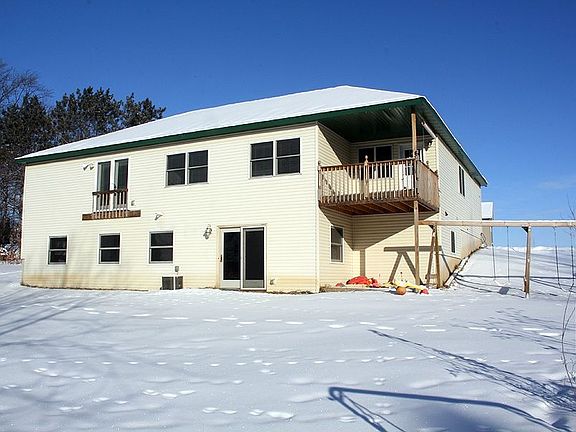 Back view.  Note the walk-out lower level, covered deck, and the large playset