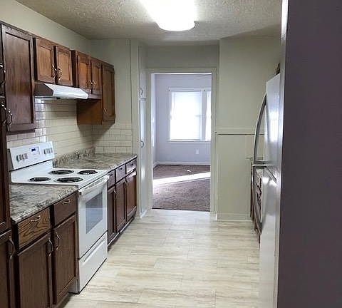 Updated kitchen. Additional cabinets and tiling have been added.