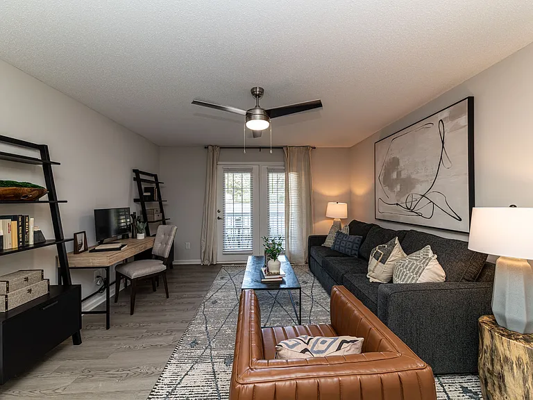 Spacious living room with hardwood-style flooring and overhead lighting