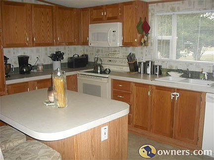 Large kitchen with window overlooking the fenced in backyard.