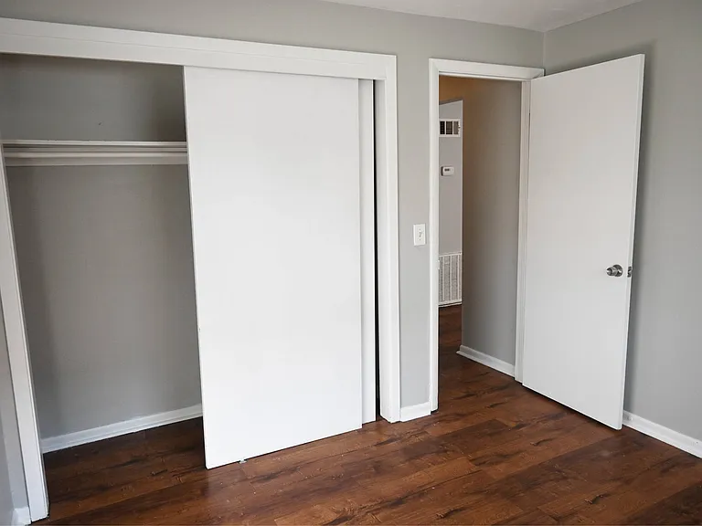 Large closet with rack in a bedroom at Benson Crest Apartments.