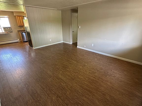 View of living room and dining nook from inside of front door.