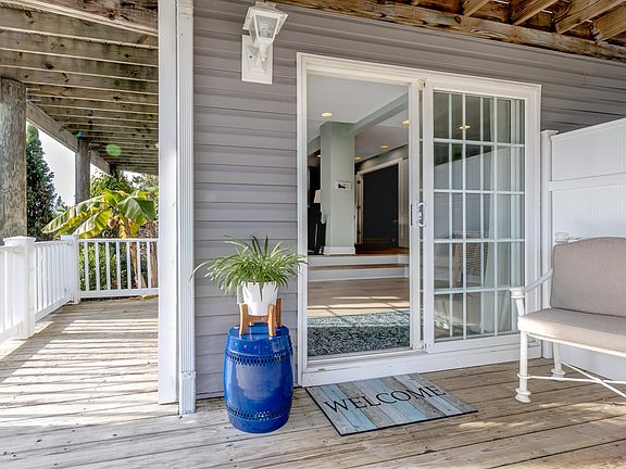 Private wrap around porch for relaxing or grilling after a day in the office, apartment or at the beach.
