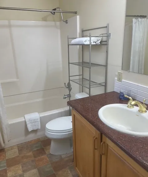 Full bath with a small window to the left.