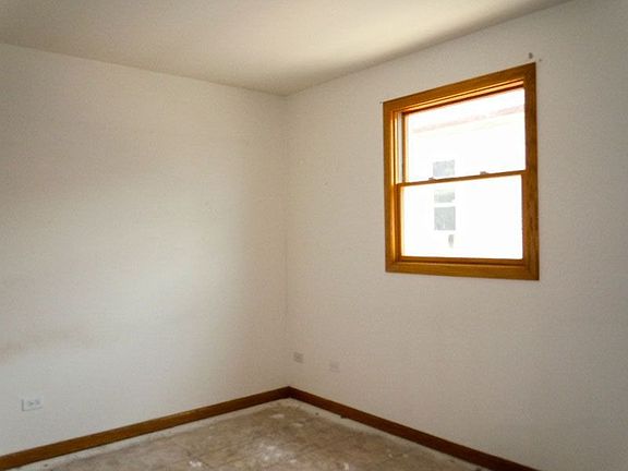 Bedroom with Neutrally Painted Walls and Floors Awaiting Finishing Touches