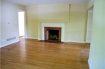 A brick fireplace is the focal point of living rm