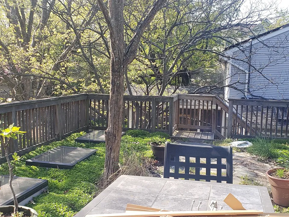 Outside patio with table that is for tenants looking towards steps.