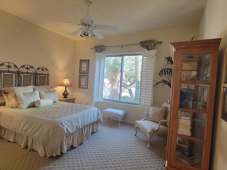 Another view of the guest bedroom. Non-fiction, fiction, southwest history books and more in the glass cabinet. This room has a view of the front patio.