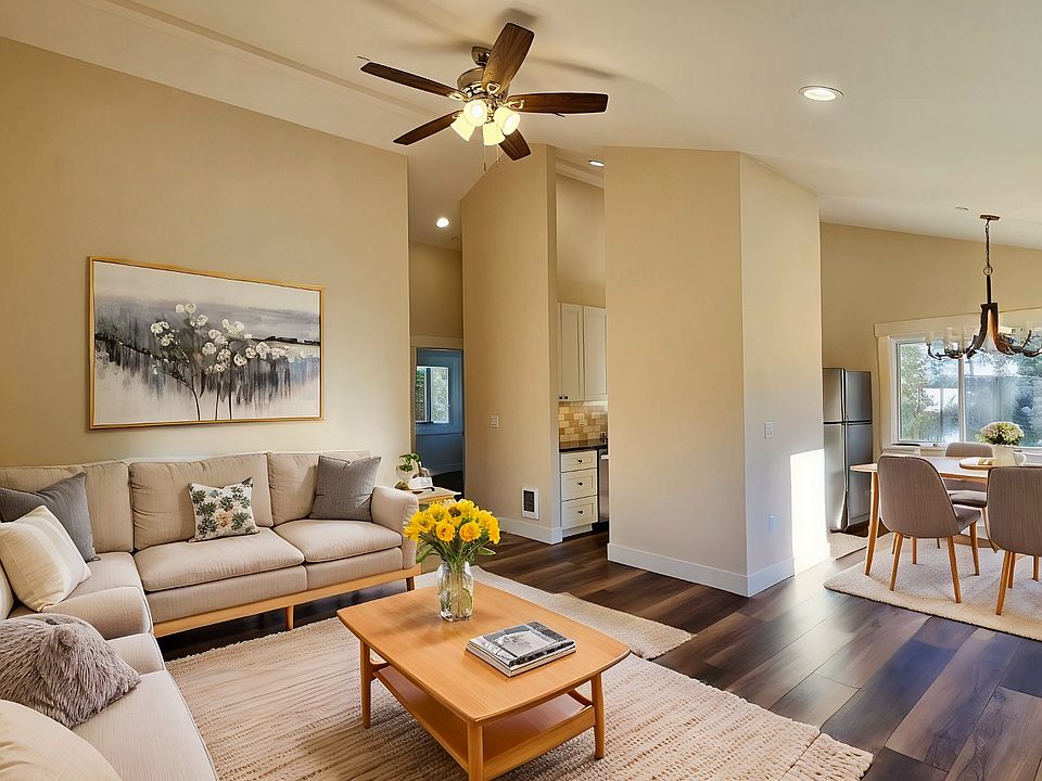 Open floor plan with vaulted ceilings and ceiling fan.