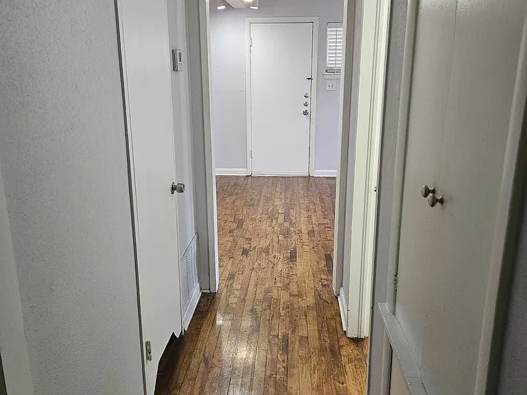 Hall to front door. Built-in linen storage, bathroom, HVAC closet.