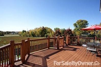 Deck overlooks large yard and pool