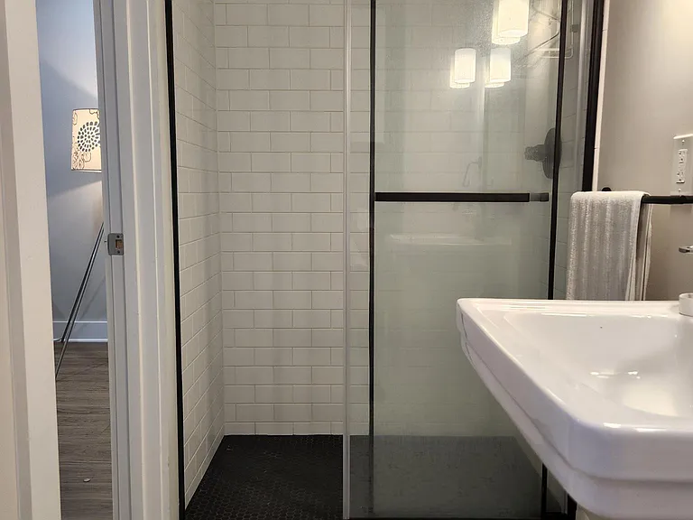 Another view of bathroom with door open out to living room area.