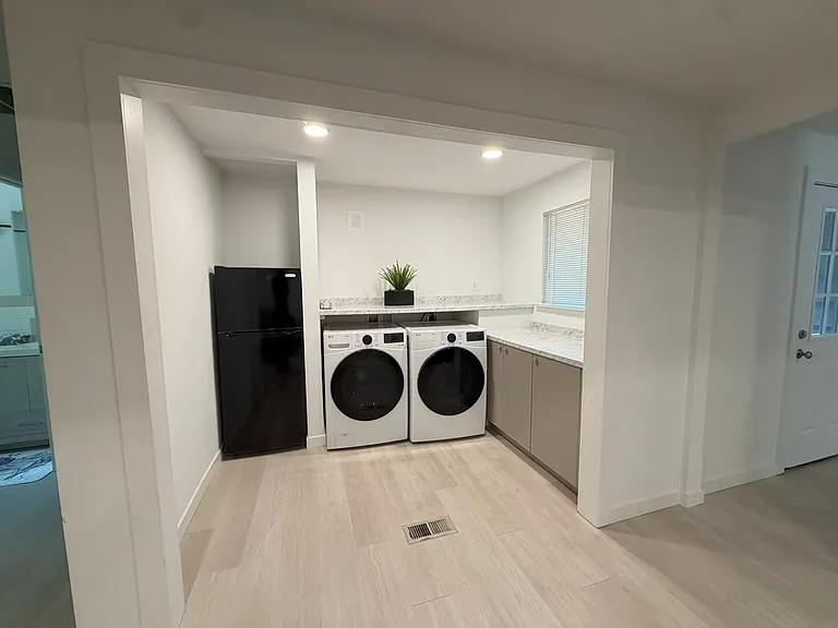 Washer / dryer / small refrigerator off living room