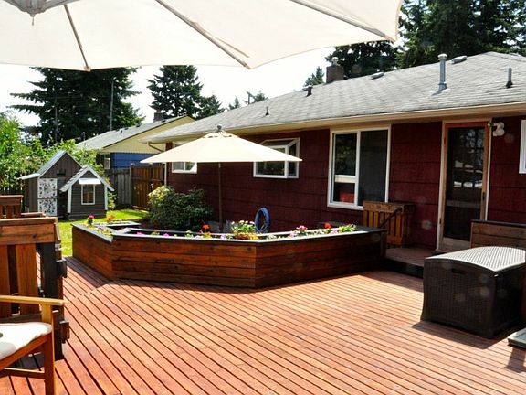 Large multi-level deck leads to level yard great for playtime.