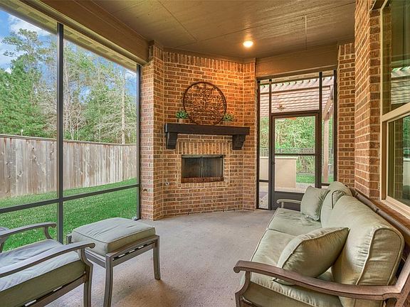The screened porch includes a cozy fireplace.