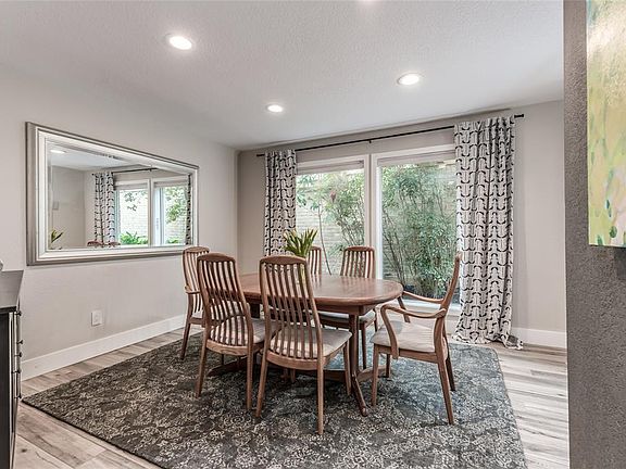 Cleverly placed formal dining in the heart of the living spaces, offering the ultimate flow in entertaining with recessed lighting and oversized double paned windows with views out to your side garden..