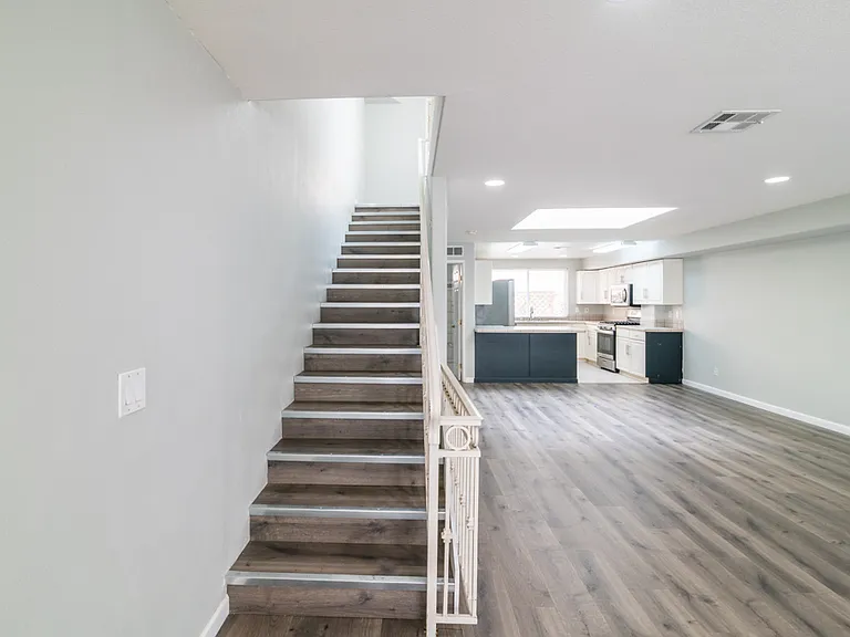 Stairs to third floor, 2nd, & 3rd ensuite bedrooms/bathrooms & laundry closet