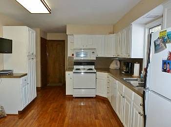 Newer white kitchen with enough room for more cabinets/counters or a breakfast table.  The oak hardwood floors that flow throughout the first floor are beautiful.