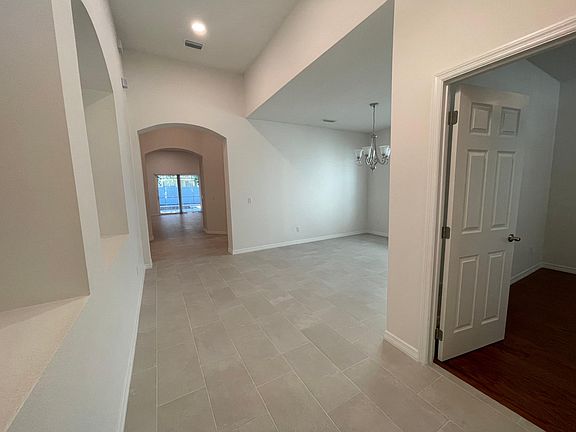 View into interior of home from front door. 4th bedroom on right side.