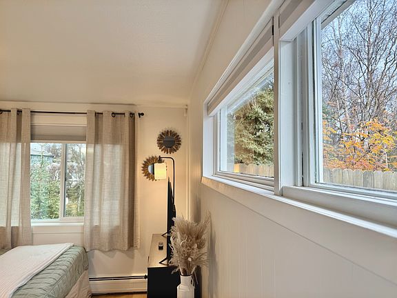 Several windows for daylight, plus blackout blinds for long summer days.