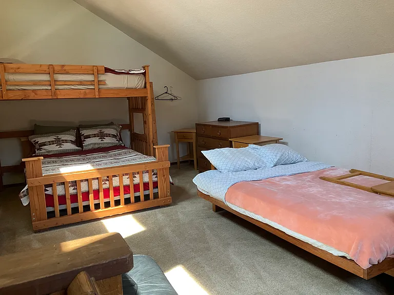 Loft with full size bed, single bunk, full futon which can be used as couch or bed.