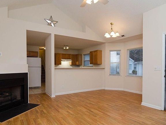 Front door, partial view of living room and full view of dining area/kitchen
