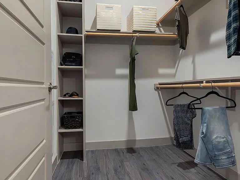 Spacious Walk-In Closet with Built-In Shelving and Ample Hanging Space