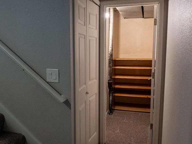 Basement extra storage. Doors on left are under stair storage space too