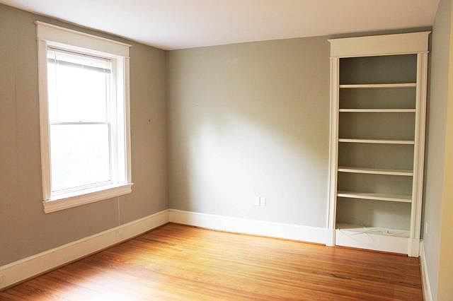Livingroom, large windows overlooking park, built-in bookcase