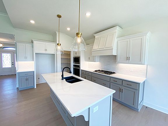 Kitchen features a breakfast bar, walk in pantry and under cabinet lighting
