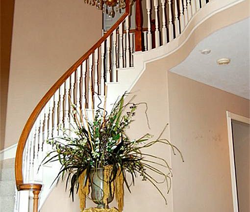 Upon entry into the foyer, you will be greeted with beautiful wood flooring abound, spiral stair case and a custom light fixture.