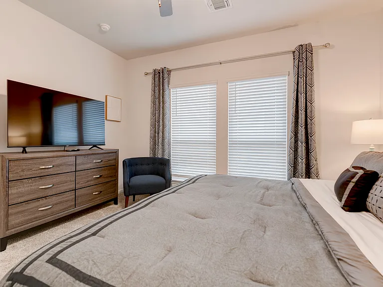 Master Bedroom with additional seating, 55-inch Roku TV and en-suite bathroom
