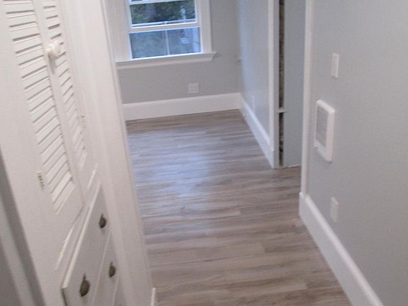 View coming into the apartment. Laminate floors and tile in bath for easy clean up.