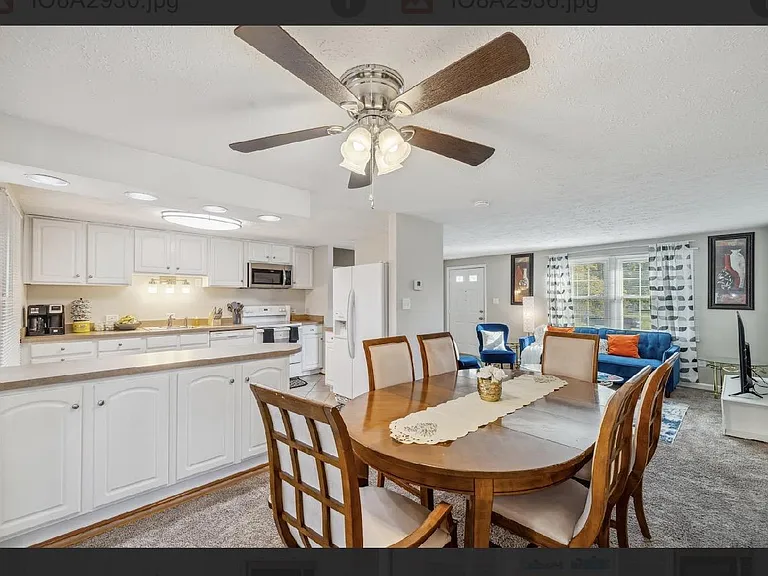 Open-concept kitchen and dining area with ample cabinetry, full appliance suite, and nearby living space for easy gatherings.