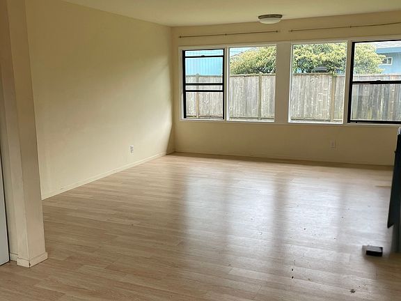 Large Sunny Living Room Taken From Dining Room with South-Facing View To Large Back Yard...Double-Paned Windows Throughout