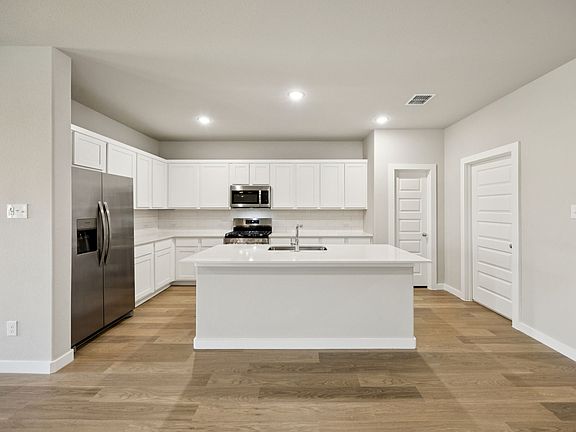 Kitchen in the Oscar home plan by Trophy Signature Homes - REPRESENTATIVE PHOTO