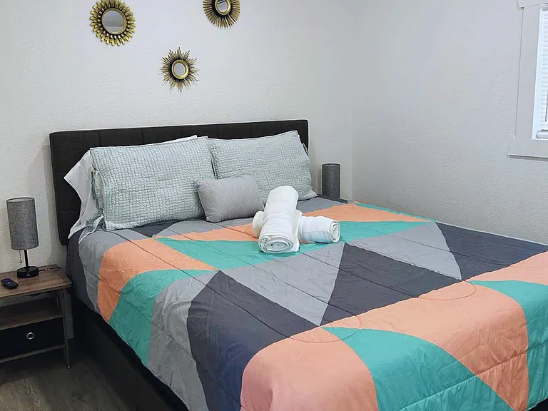 Comfortable room with queen bed and nightstands.