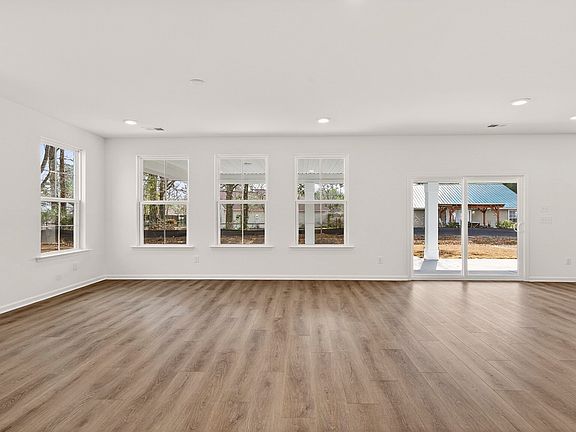 Spacious Pritchard living room with sliding glass door for easy outdoor access