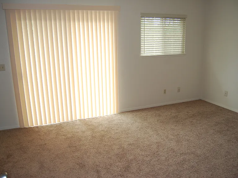 Master bedroom with master bath, large closet, and private entrance to the rear yard.