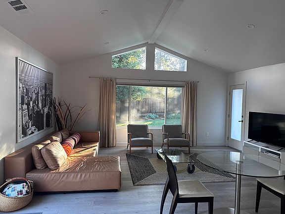 Furnished living room with leather sofa, and armchairs