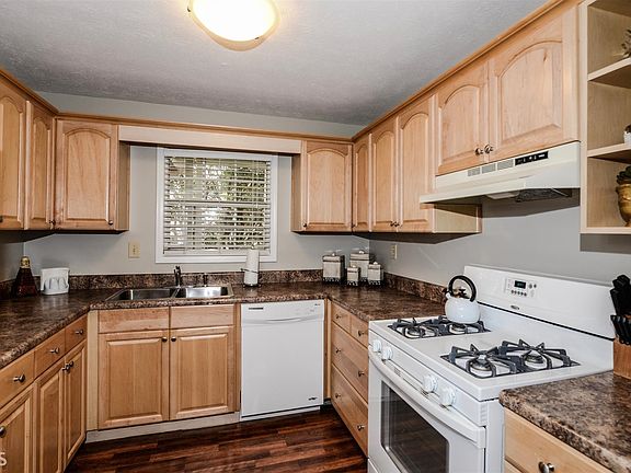 The spacious kitchen offers ample counter-top space and cabinet storage and is open to the dining ar