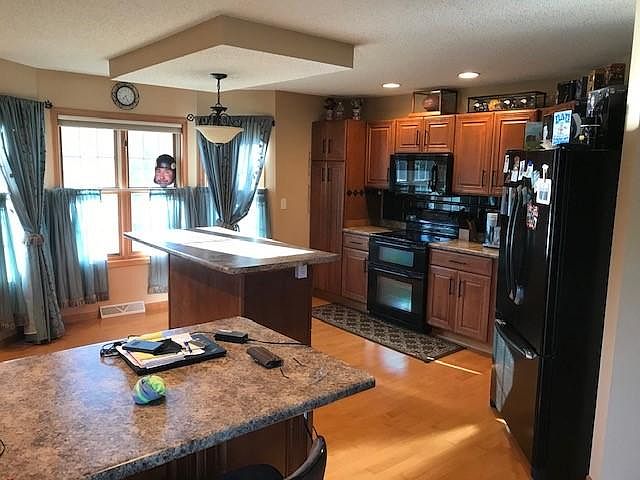 Kitchen with center island and breakfast bar sitting area