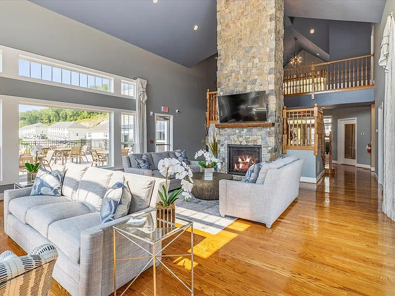 Clubhouse with great room, fireplace, flat screen TV, and modern furniture.