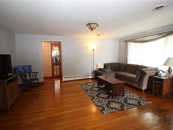 Huge living room window allows natural light to gleam off the original hardwood floors found throughout the main floor.
