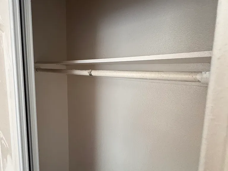 Closet with shelf and hanging rod.