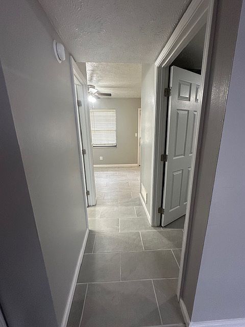 Hallway from living room 
Right door - goes into laundry room
Left door - goes into half bath
Open at the end is the dining / kitchen and back door area